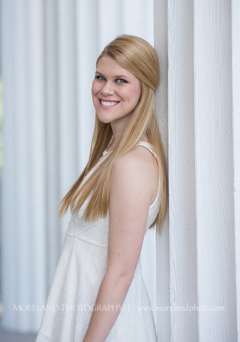 mikemoreland, morelandphoto, girl, outdoors, medium close-up, soft lighting, big smile, white dress, big building
