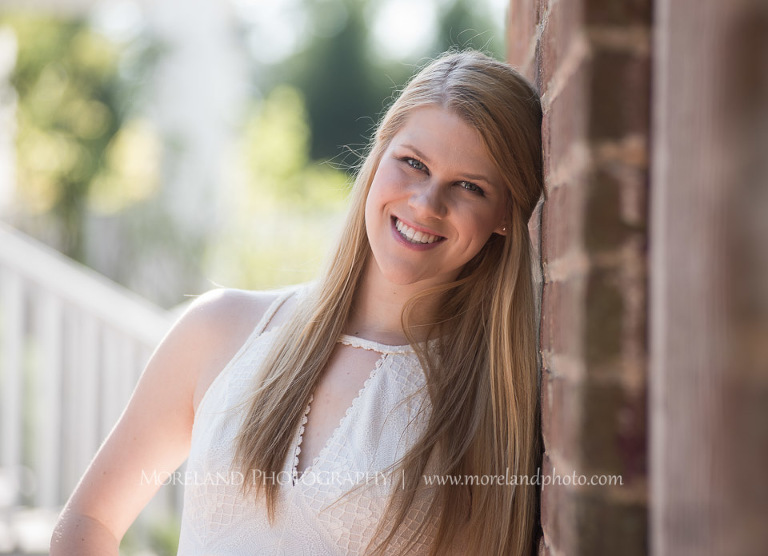 mikemoreland, morelandphoto, girly, outdoors, medium close-up, soft lighting, big smile, white dress, against a wall