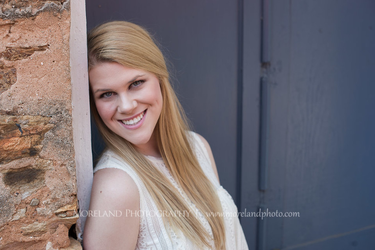 mikemoreland, morelandphoto, girly, outdoors, medium close-up, soft lighting, big smile, white dress, against a doorframe