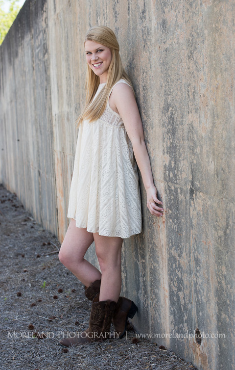 mikemoreland, morelandphoto, sweet, girly, outdoors, full shot, soft lighting,leaning on a wall, big smile, white dress, boots