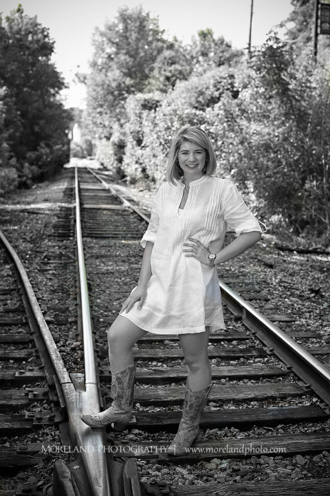 High school senior posing on abandoned railroad tracks, Roswell Senior Photography, Atlanta Senior Portraits, Senior Photography, Atlanta Senior Photography, Moreland Photography, Mike Moreland, Class of 2016, mikemoreland, morelandphoto, excitement, class of 2016, country girl, sparkling future, big grin, posing by train tracks, white blouse, model portrait, afternoon, cowgirl boots, black and white photography