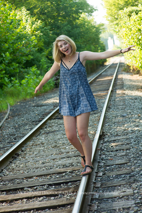 High school senior posing on abandoned railroad tracks, Roswell Senior Photography, Atlanta Senior Portraits, Senior Photography, Atlanta Senior Photography, Moreland Photography, Mike Moreland, Class of 2016, mikemoreland, morelandphoto, excitement, class of 2016, country girl, sparkling future, big grin, posing by train tracks, mixed color blouse, model portrait, afternoon, playing on the railroad, having fun pose