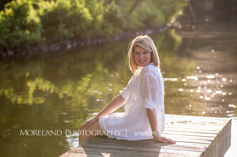High school senior sitting on a pier with her legs hanging over, Roswell Senior Photography, Atlanta Senior Portraits, Senior Photography, Atlanta Senior Photography, Moreland Photography, Mike Moreland, Class of 2016, mikemoreland, morelandphoto, excitement, class of 2016, country girl, sparkling future, big grin, classy and sassy, model portrait, white blouse, afternoon, yearbook editor, having fun, sitting by the dock