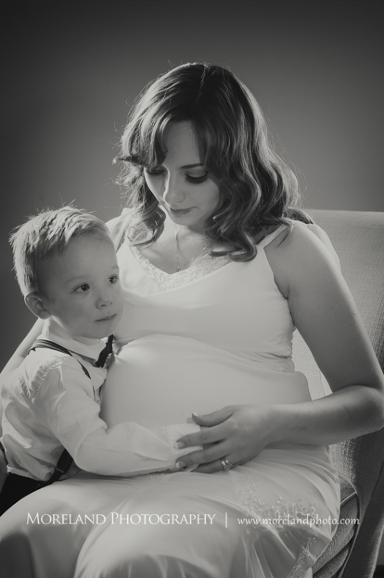 Little boy feeling his mother's pregnant belly and his mom is also holding the little boy, hollywood maternity, beautiful, serene, love, joy, happiness, classic, timeless