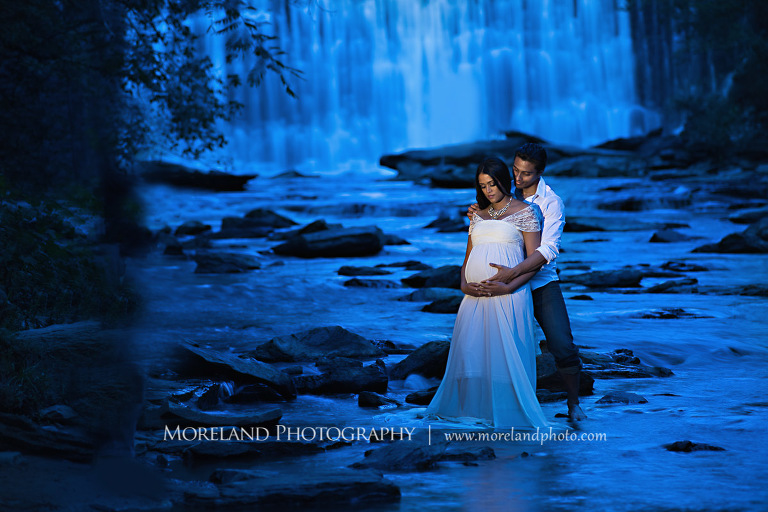 Indian couple expecting their first baby standing by a waterfall, serene , tranquil, love, peaceful, joy, happiness, protection, natural, nature