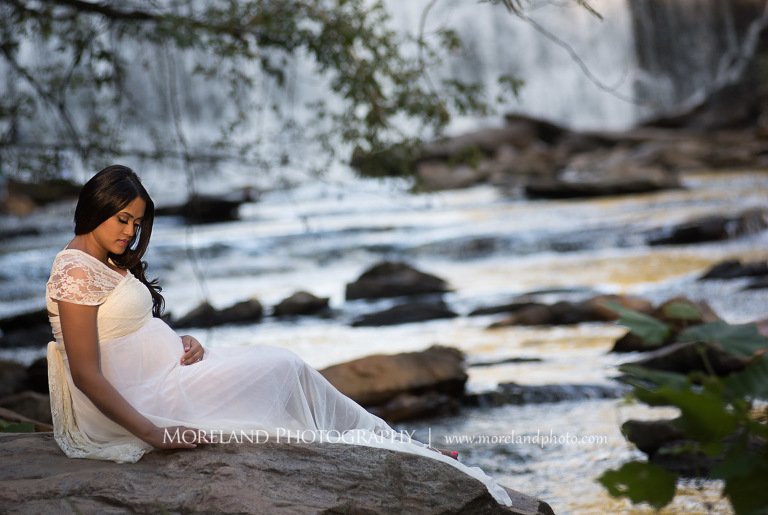 Pregnant Indian woman sitting down by a waterfall, beautiful, love, adoration, nature, natural, joy, romance, peaceful, protection, serene