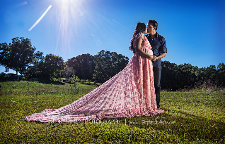 Indian husband sharing an intimate moment with his pregnant wife in an open field on a sunny day, outdoor maternity, naturalistic maternity, beautiful, love, peaceful, beautiful, joy, happiness, expecting