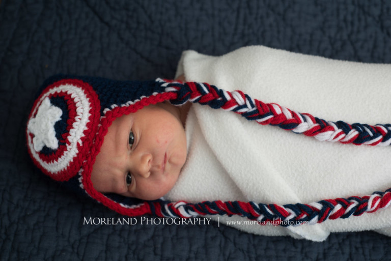 Newborn baby wearing a red white and blue hat while being wrapped in a blanket, Newborn Family Photography, Atlanta Family Photography, Family Photographer Atlanta, Atlanta Photographer, Moreland Photography, Mike Moreland, Four kids, Large family, Fall Family Pictures, 