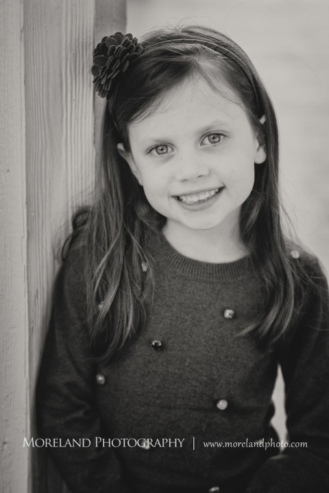 Little girl smiling as she leans against the wall, Atlanta Family Photography, Family Photographer Atlanta, Atlanta Photographer, Moreland Photography, Mike Moreland, Four kids, Large family, Fall Family Pictures, 