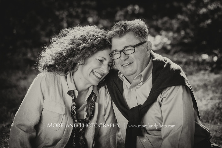 Black and white portrait of a smiling couple cuddleing sitting in the grass outside in the daytime, Atlanta Portrait Photographer, Atlanta Child Photographer, Atlanta Family Photographer, Moreland Photography, Mike Moreland