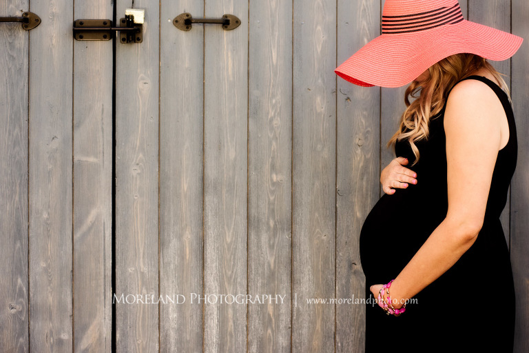 Pregnant woman holding her stomach as she leaned against a barn, Atlanta Maternity Photographer, Maternity Photos Atlanta, Georgia Maternity Photography, Moreland Photography, Mike Moreland, Outdoor Maternity, Maternity on the River, 