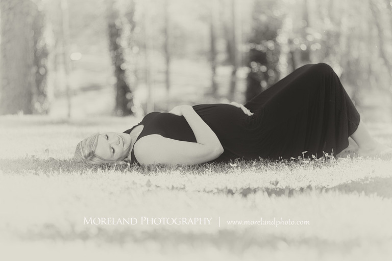 Pregnant woman laying on the grass while touching her belly, Atlanta Maternity Photographer, Maternity Photos Atlanta, Georgia Maternity Photography, Moreland Photography, Mike Moreland, Outdoor Maternity, Maternity on the River, 
