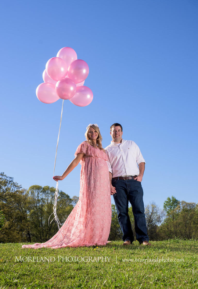 Husband and pregnant wife hold hands as she holds pink balloons in her other hand, Atlanta Maternity Photographer, Maternity Photos Atlanta, Georgia Maternity Photography, Moreland Photography, Mike Moreland, Outdoor Maternity, Maternity on the River, 