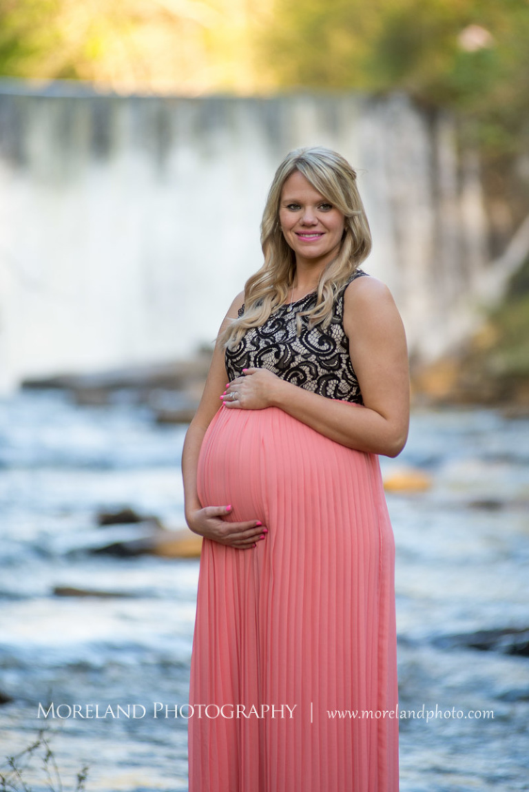 Pregnant woman wearing a pink dress with a waterfall in the background, Atlanta Maternity Photographer, Maternity Photos Atlanta, Georgia Maternity Photography, Moreland Photography, Mike Moreland, Outdoor Maternity, Maternity on the River, 