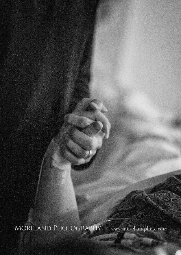 Grey-scale image of a father holding his wife's hand as she is in labor, birth photography, birth newborn photography, Atlanta Newborn Photography, Newborn Photographer Atlanta, Birth Photography, Natural Birth Photography, Hospital Photographer, Moreland Photography, Mike Moreland