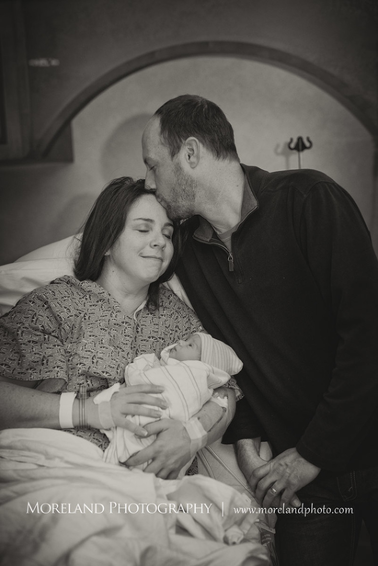 Grey-scale image of a father kissing his wife's forehad after she has just given birth to their newborn son, Atlanta Newborn Photography, Newborn Photographer Atlanta, Birth Photography, Natural Birth Photography, Hospital Photographer, Moreland Photography, Mike Moreland