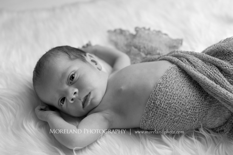 Grey-scale image of a newborn baby swaddled in a knotted blanket while on top of a fluffy pillow, Atlanta Newborn Photography, Newborn Photographer Atlanta, Birth Photography, Natural Birth Photography, Hospital Photographer, Moreland Photography, Mike Moreland