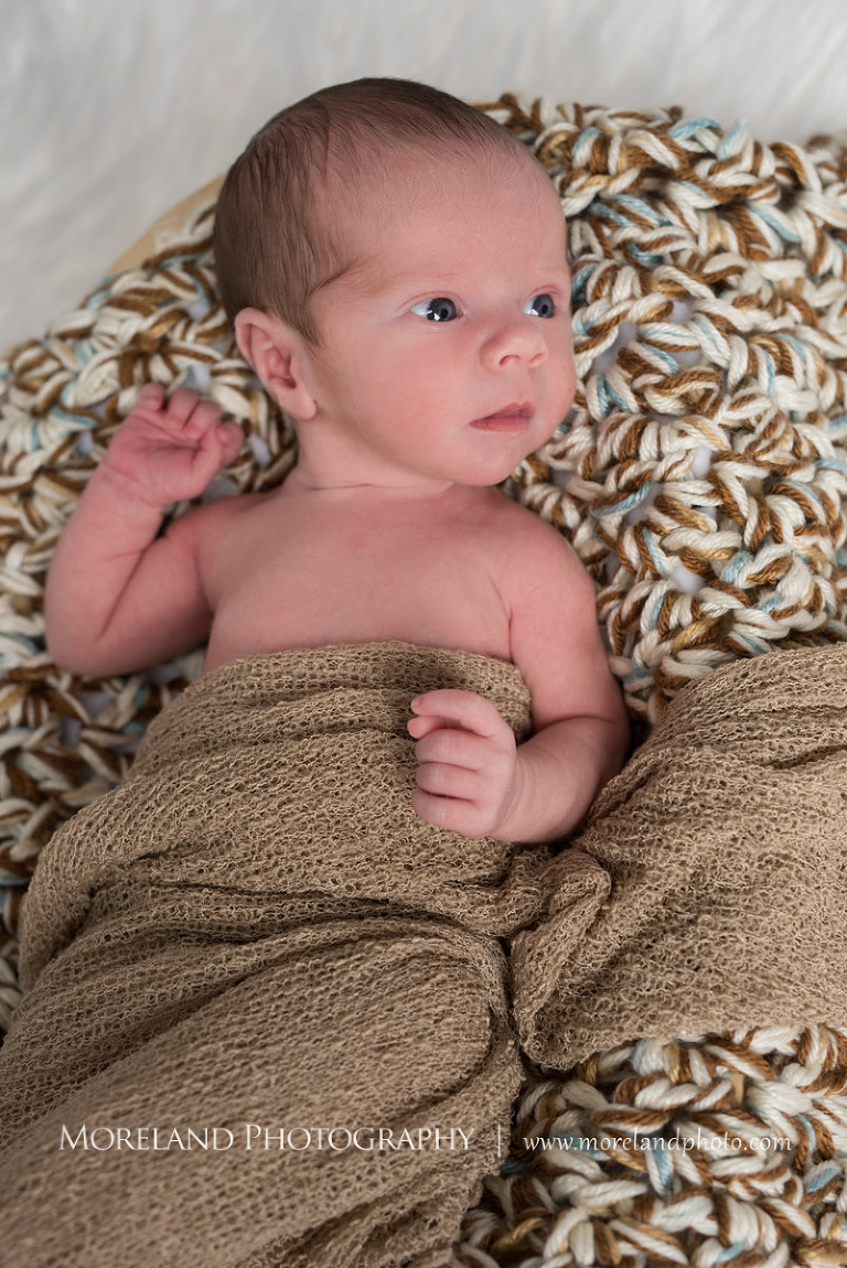 Newborn baby wrapped partly in a blanket while on top of a corochet pillow, Atlanta Newborn Photography, Newborn Photographer Atlanta, Birth Photography, Natural Birth Photography, Hospital Photographer, Moreland Photography, Mike Moreland