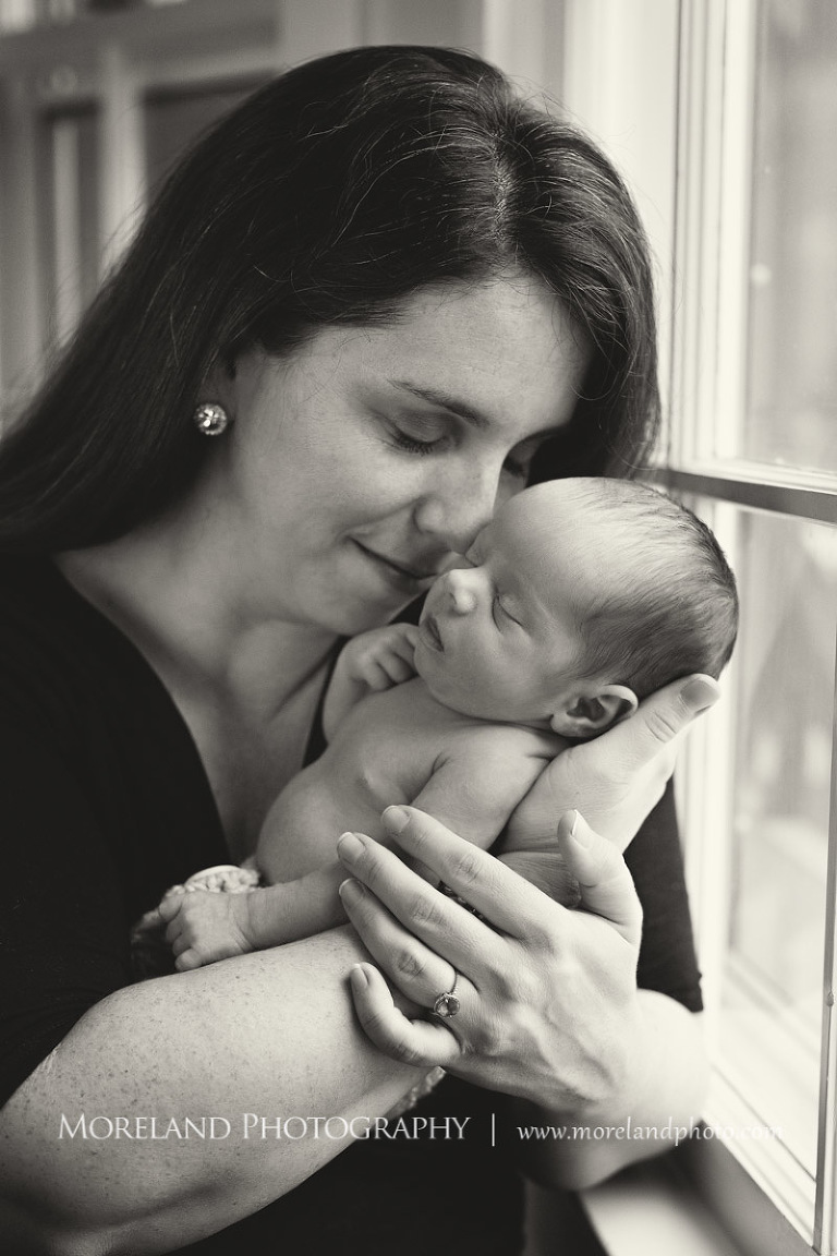 A mother holding her newborn son close whole standing next to a window, Atlanta Newborn Photography, Newborn Photographer Atlanta, Birth Photography, Natural Birth Photography, Hospital Photographer, Moreland Photography, Mike Moreland