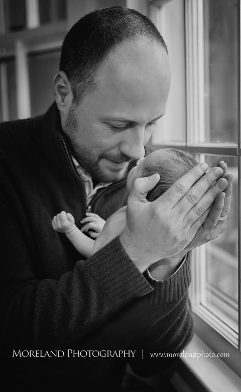 Grey-scale image of a father holding his newborn son close in his arms while standing next to a window, Atlanta Newborn Photography, Newborn Photographer Atlanta, Birth Photography, Natural Birth Photography, Hospital Photographer, Moreland Photography, Mike Moreland