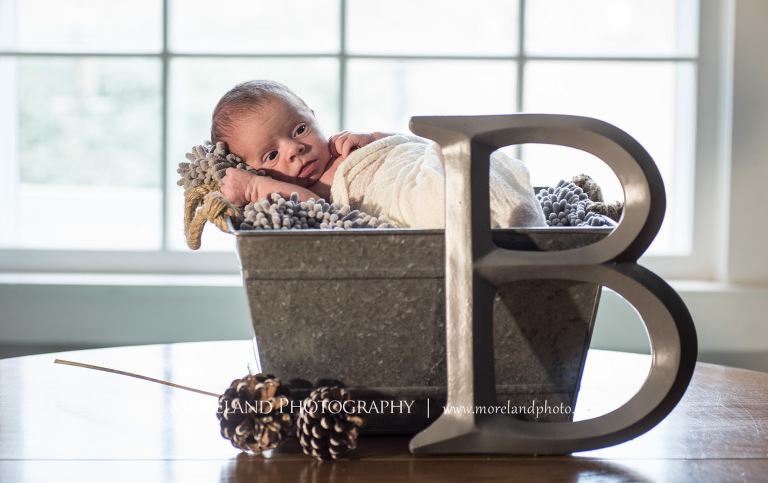 Newborn baby boy laying in a bucket with blankets on a table with a large letter B propped against it, Atlanta Newborn Photography, Newborn Photographer Atlanta, Birth Photography, Natural Birth Photography, Hospital Photographer, Moreland Photography, Mike Moreland