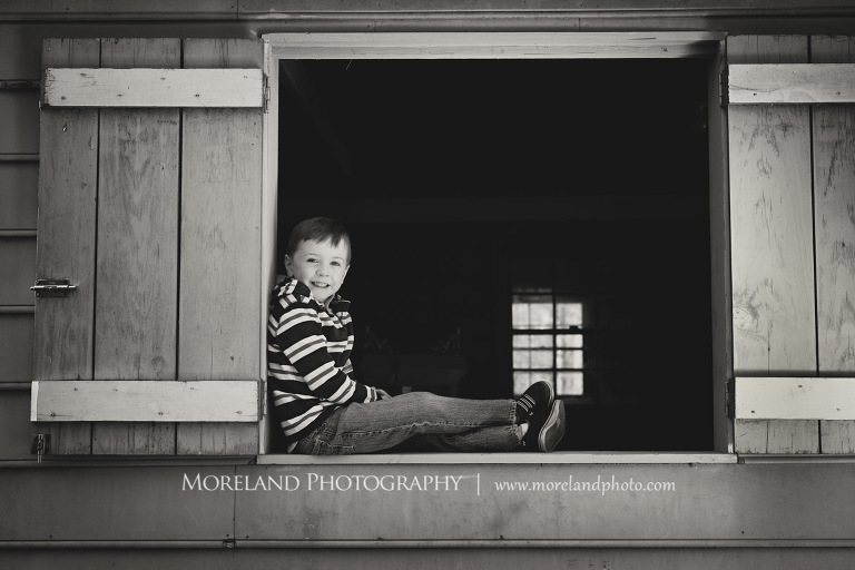 Grey-scale image of a young boy sitting in the window sill of a barn, Atlanta Newborn Photography, Newborn Photographer Atlanta, Birth Photography, Natural Birth Photography, Hospital Photographer, Moreland Photography, Mike Moreland