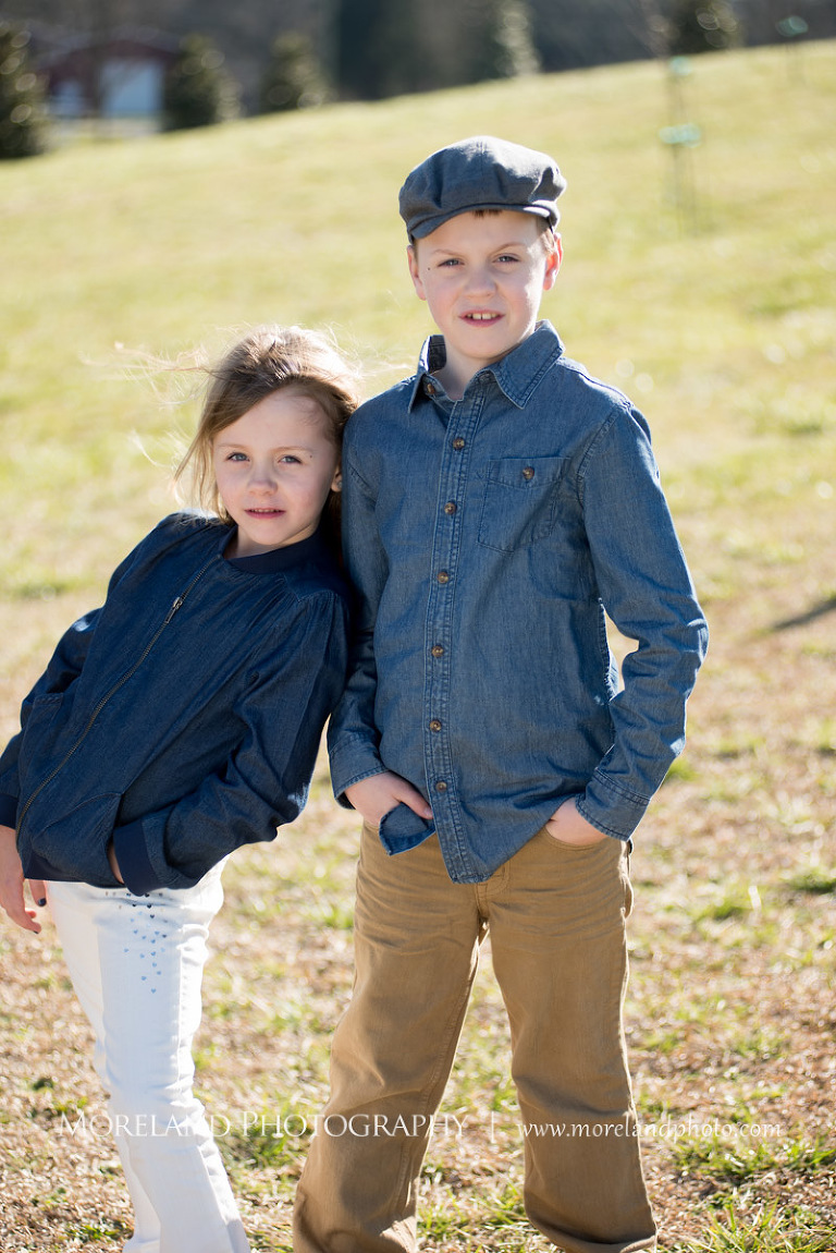 Medium shot of the two oldest siblings of the family standing outside in an open field next to each other, Atlanta Newborn Photography, Newborn Photographer Atlanta, Birth Photography, Natural Birth Photography, Hospital Photographer, Moreland Photography, Mike Moreland