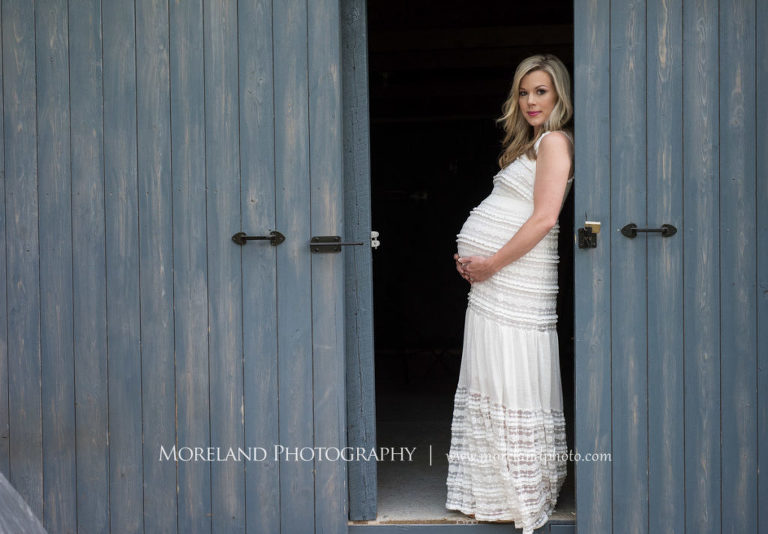Portrait of pregnant woman wearing a white maternity gown standing in the door of a barn, Maternity Photography, Atlanta Maternity, Lifestyle Maternity Photography, Styled Maternity Shoot, Moreland Photography, Mike Moreland, Outdoor Maternity, Nature Maternity, 