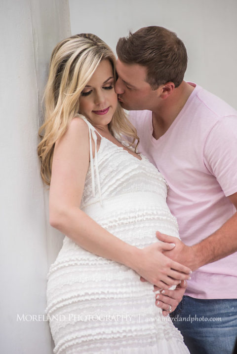 Portrait of husband holding pregnant wife's belly and kissing her cheek leaning against column outside, Maternity Photography, Atlanta Maternity, Lifestyle Maternity Photography, Styled Maternity Shoot, Moreland Photography, Mike Moreland, Outdoor Maternity, Nature Maternity, 