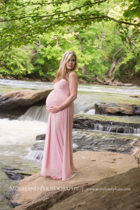 Portrait of pregnant woman standing outside on a rock wearing a pink gown holding her belly, Maternity Photography, Atlanta Maternity, Lifestyle Maternity Photography, Styled Maternity Shoot, Moreland Photography, Mike Moreland, Outdoor Maternity, Nature Maternity, 