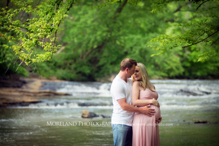 Portrait of pregnant couple looking at each other standing in front of a river, Maternity Photography, Atlanta Maternity, Lifestyle Maternity Photography, Styled Maternity Shoot, Moreland Photography, Mike Moreland, Outdoor Maternity, Nature Maternity, 