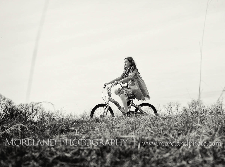 little girl riding a bicycle through a field, Childen Ballet, Child Portraits, Atlanta Photgraphy, Moreland Photography, Roswell Portraits, ballet shoes, dancer, black and white, bicycle,