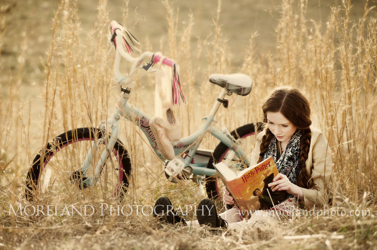 little girl reading beside a bicycle in tall grass, Childen Ballet, Child Portraits, Atlanta Photgraphy, Moreland Photography, Roswell Portraits, ballet shoes, dancer, bicycle, Harry Potter, reading,