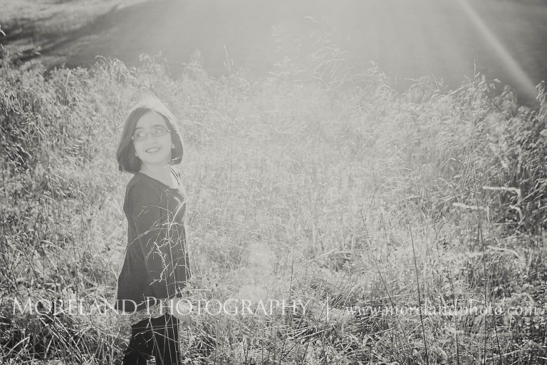 Sun shining on a grass while little girl wall, Twin Portraits, Child Portraits, Atlanta Photgraphy, Moreland Photography, Roswell Portraits, twins, tall grass, sister,