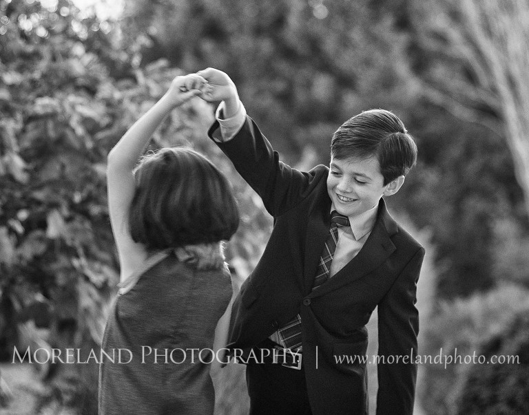 Twin sibling dancing together in black and white, Twin Portraits, Child Portraits, Atlanta Photgraphy, Lifestyle photography, Moreland Photography, Roswell Portraits, twins, tall grass, brother, sister, black and white,