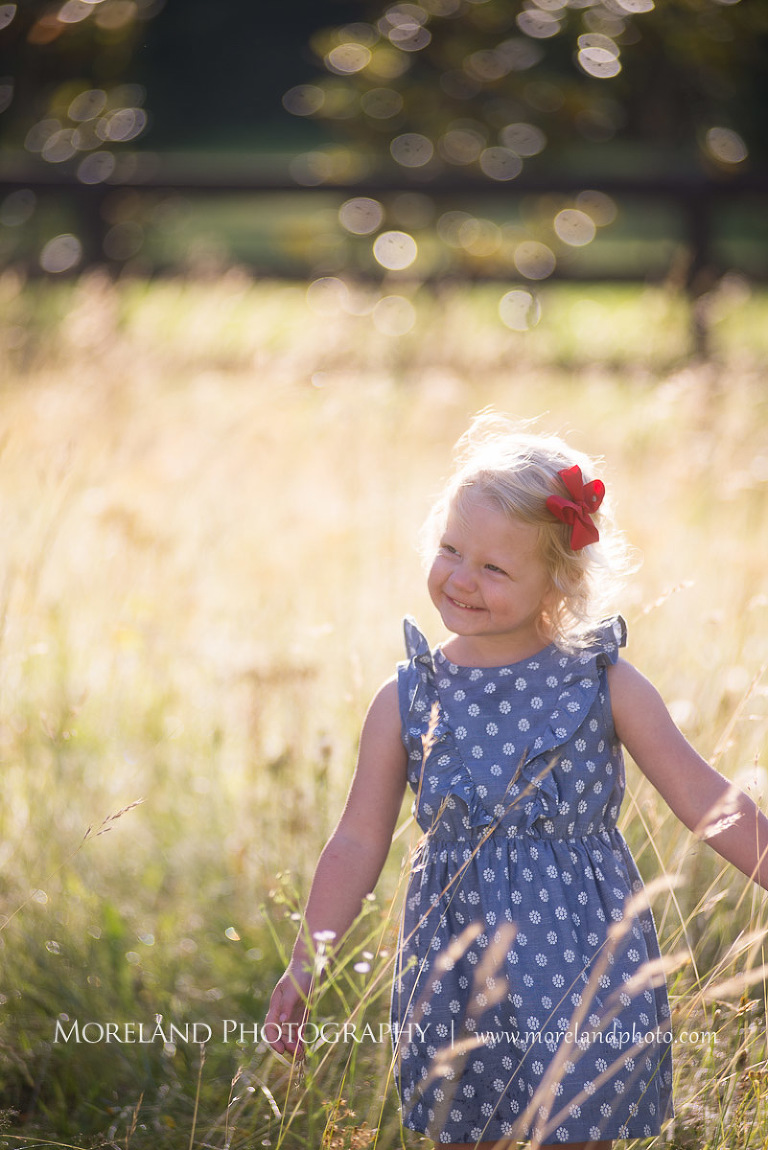 little girl smiling in a polka dot in a field, Mike Moreland, Moreland Photography, wedding photography, Atlanta wedding photography, detailed wedding photography, lifestyle wedding photography, Atlanta wedding photographer,