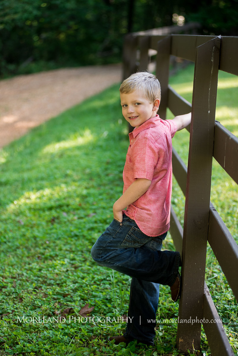 boy in red button down on fence post smiling, Mike Moreland, Moreland Photography, wedding photography, Atlanta wedding photography, detailed wedding photography, lifestyle wedding photography, Atlanta wedding photographer,