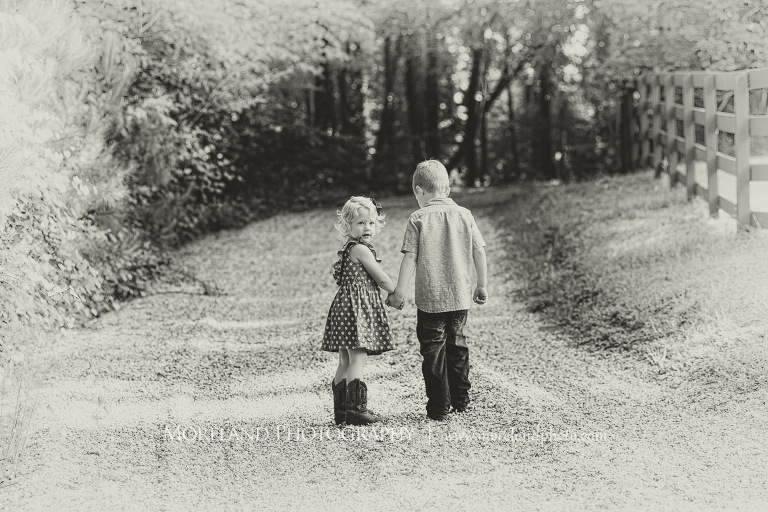 brother and sister holding hands on a dirt road in the woods black and white, Mike Moreland, Moreland Photography, wedding photography, Atlanta wedding photography, detailed wedding photography, lifestyle wedding photography, Atlanta wedding photographer,