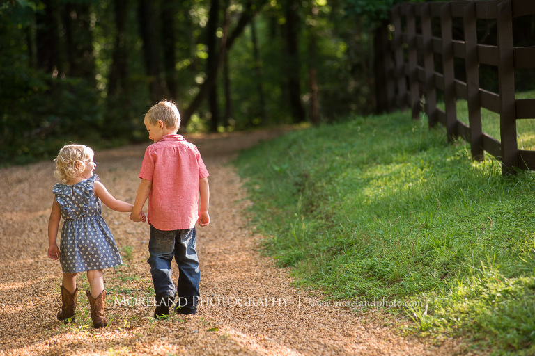 brother and sister holding hands on dirt road in the woods, Mike Moreland, Moreland Photography, wedding photography, Atlanta wedding photography, detailed wedding photography, lifestyle wedding photography, Atlanta wedding photographer,