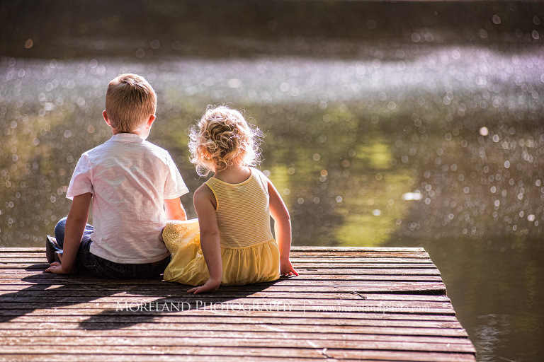 brother and sister sitting on wooden dock by the lake, Mike Moreland, Moreland Photography, wedding photography, Atlanta wedding photography, detailed wedding photography, lifestyle wedding photography, Atlanta wedding photographer,