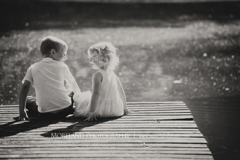 sister and brother sitting on dock by the lake black and white, Mike Moreland, Moreland Photography, wedding photography, Atlanta wedding photography, detailed wedding photography, lifestyle wedding photography, Atlanta wedding photographer,