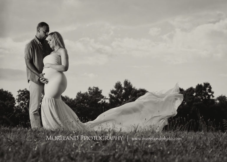 Black and white pregnant woman with husband standing in field wearing flowy maternity dress, Mike Moreland, Moreland Photography, Atlanta Portrait Photographer, Maternity Photography Atlanta
