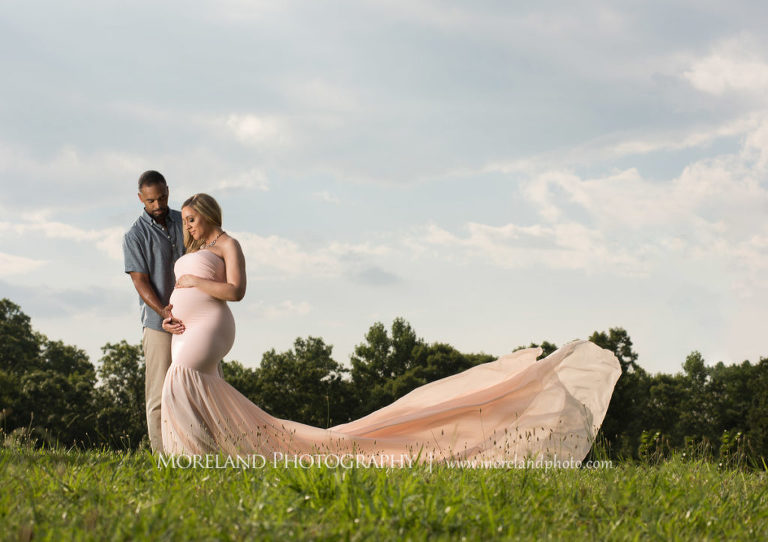 Pregnant woman with husband standing in field wearing pink, flowy maternity dress, Mike Moreland, Moreland Photography, Atlanta Portrait Photographer, Maternity Photography Atlanta