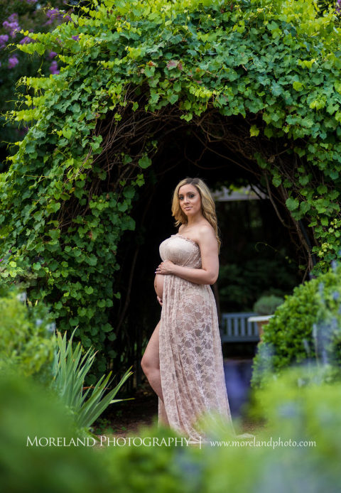 Pregnant woman standing in English garden under archway wearing pink, flowy maternity dress, Mike Moreland, Moreland Photography, Atlanta Portrait Photographer, Maternity Photography Atlanta