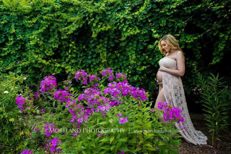 Pregnant woman standing in English garden wearing pink, flowy maternity dress, spring maternity shoot, Mike Moreland, Moreland Photography, Atlanta Portrait Photographer, Maternity Photography Atlanta