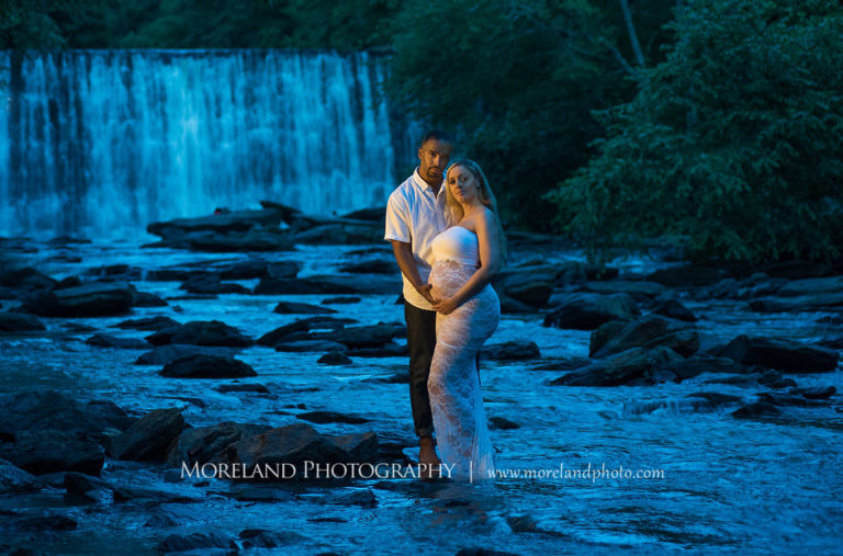 Pregnant woman and husband standing in front of waterfall wearing white, lacey maternity dress, Mike Moreland, Moreland Photography, Atlanta Portrait Photographer, Maternity Photography Atlanta