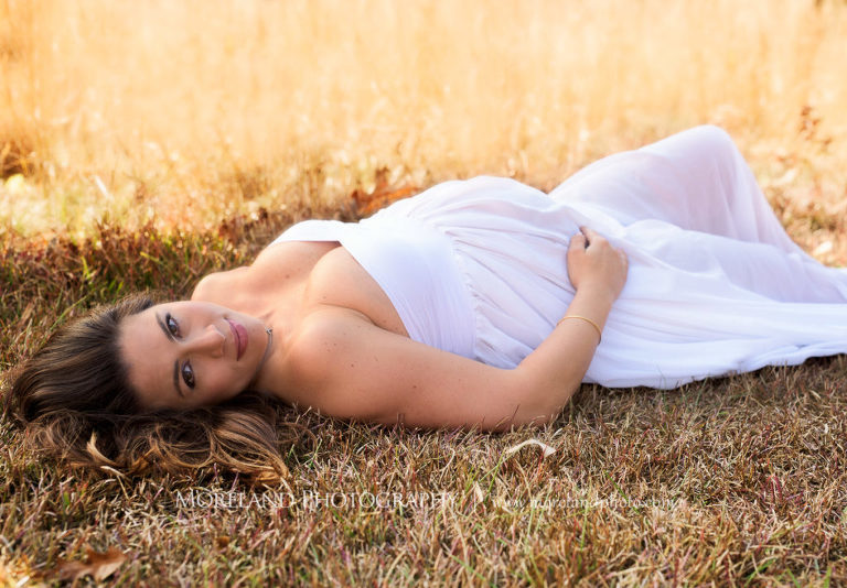 Pregnant woman laying down in a white dress in an open field, Mike Moreland, Moreland Photography, Outdoor Photography, Atlanta Portrait Photographer, Maternity Photography Atlanta, New Born Photography, New Born Photography Atlanta, Baby, Downtown Atlanta, Family, Mother, Father, 