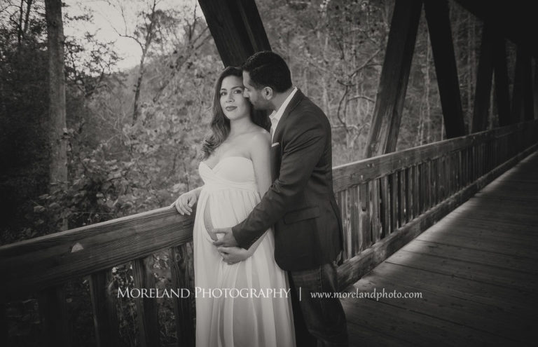 Maternity shoot of father kissing mother on long wooden bridge, Mike Moreland, Moreland Photography, Atlanta Portrait Photographer, Maternity Photography Atlanta, New Born Photography, New Born Photography Atlanta, Baby, Downtown Atlanta, Family, Mother, Father, Black and white 