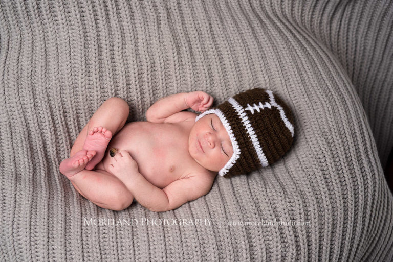 New born baby sleeping with a football hat on a grey blanket, Mike Moreland, Moreland Photography, Atlanta Portrait Photographer, Maternity Photography Atlanta, New Born Photography, New Born Photography Atlanta, Baby, Downtown Atlanta, 