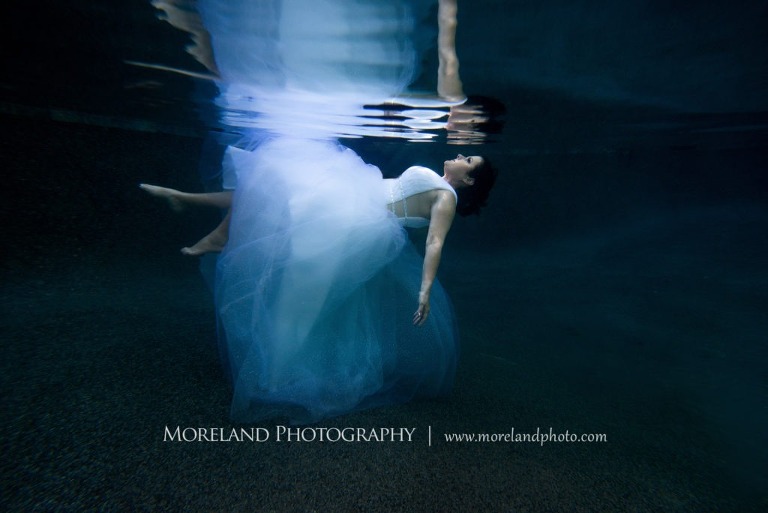 Woman in blue dress laying beautifully underwater, underwater pictures, creative photography atlanta, creative edge workshops, moreland photography, creative underwater photo shoot, underwater photography, nikon underwater, Georgia underwater photography, leading underwater photographer, artful photography, beautiful photo, graceful underwater portrait, nikon underwater photographer